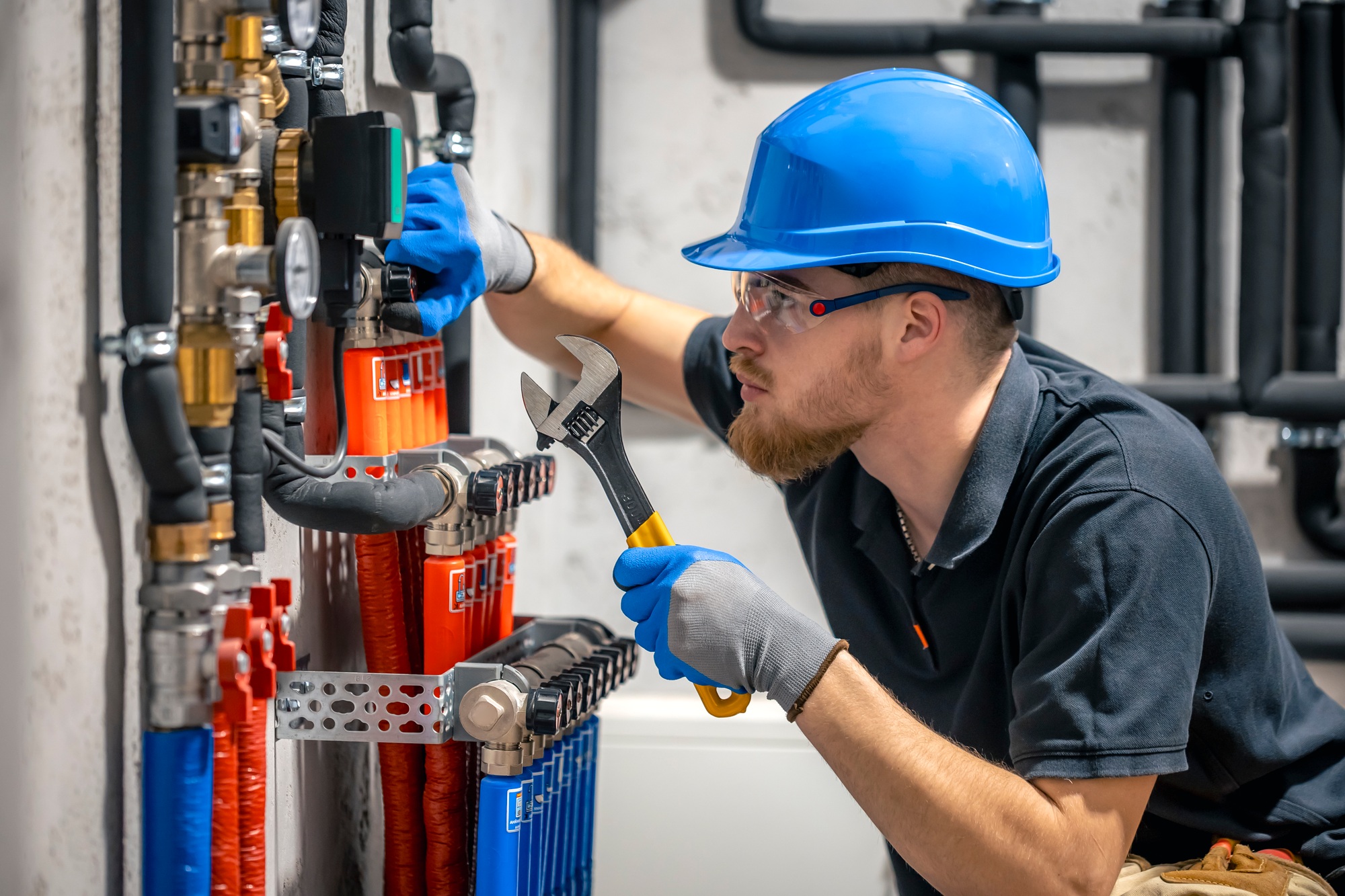 The technician checking the heating system in the boiler room.